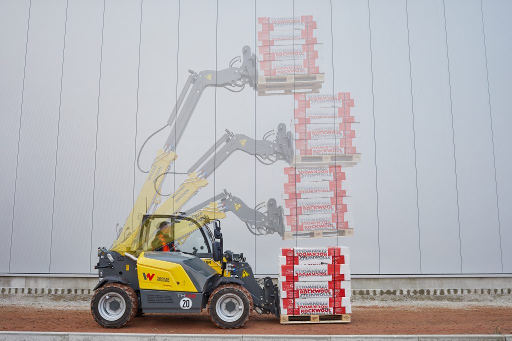 Telehendler Wacker Neuson pri slaganju paleta na visinu.